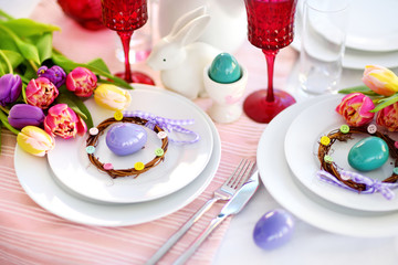 Beautiful table setting with crockery and flowers for Easter celebration