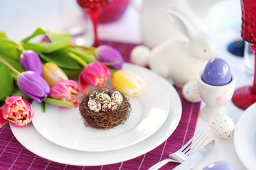Beautiful table setting with crockery and flowers for Easter celebration