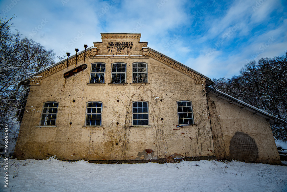 Wall mural old brick building and snow on the ground