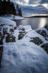 snow and cliffs by the lake