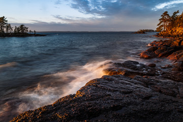 Fototapeta na wymiar powerful waves against rocks at sunset