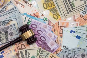 Judge gavel on dollars and euro banknotes