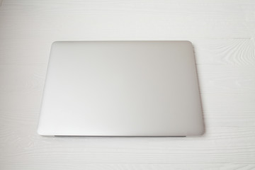 Laptop on a wooden background. Top view. Free space for text.