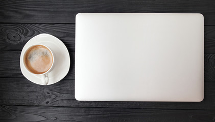 Laptop on a wooden background. Top view. Free space for text.