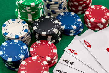 playing cards and casino poker chips on green