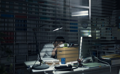 Fired office worker holding a box