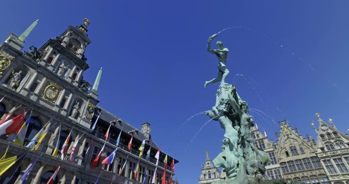 Bravo statue in Grat Market square in the center of Antwerp, Belgium on a sunny day.  City Hall in the background. Cinematic camera movement.