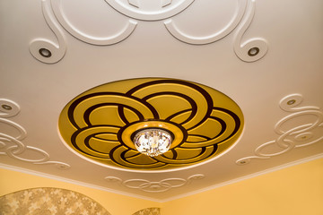 Part of the room - glossy ceiling and chandelier