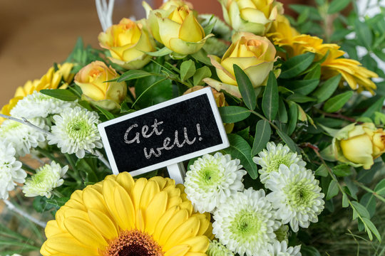 get well soon / Bouquet of yellow and white roses, gerberas, chrysanthemums and a small board with English text: get well soon