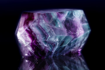 Macro mineral stone Fluorite crystal on a black background