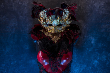 Venetian red, mask and red corset with pieces of gold and black lace fabrics on metal breastplate. handmade piea for parties or costume meetings