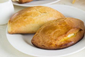Homemade pies  with cottage cheese on a white plate.