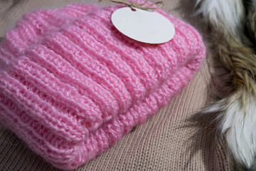 Fototapeta na wymiar Warm handmade pink winter hat for women