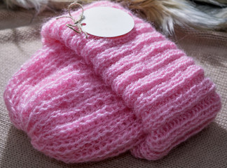 Fototapeta na wymiar Warm handmade pink winter hat for women