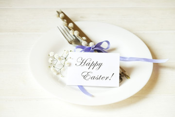 Easter laying table appointments, table setting options. Silverware, tableware items with festive decoration. Fork, knife and flowers. Happy easter holiday.