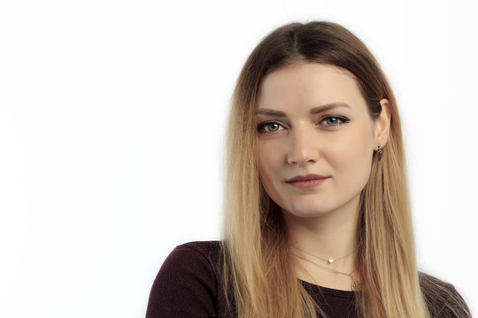 Portrait Of Young European Female With Healthy Clean Skin And Blue Eyes Wearing Casual Top Looking At Camera With Serious Expression.