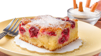 Sour cherry cake. Slices of sour cherry cake with sugar and cinnamon sticks. 