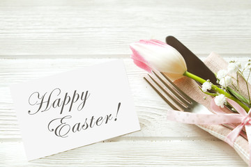 Easter laying table appointments, table setting options. Silverware, tableware items with festive decoration. Fork, knife and flowers. Happy easter holiday.