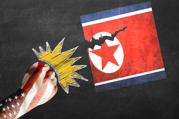 USA vs. North Korea - graphic concept. Fist decorated with USA flag knocking beating and tearing...