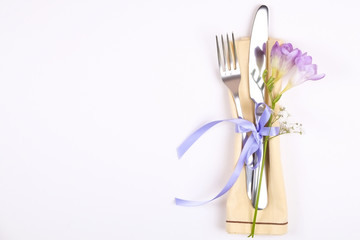 Easter laying table appointments, table setting options. Silverware, tableware items with festive decoration. Fork, knife and flowers. Happy easter holiday.