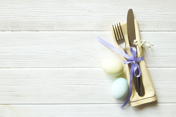 Easter laying table appointments, table setting options. Silverware, tableware items with festive decoration. Fork, knife and flowers. Happy easter holiday.