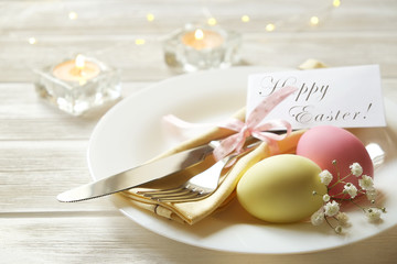 Easter laying table appointments, table setting options. Silverware, tableware items with festive decoration. Fork, knife and flowers. Happy easter holiday.