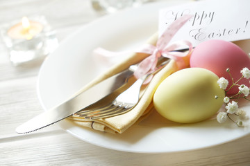 Easter laying table appointments, table setting options. Silverware, tableware items with festive decoration. Fork, knife and flowers. Happy easter holiday.