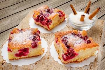 Sour cherry cake. Slices of sour cherry cake with sugar and cinnamon sticks. 
