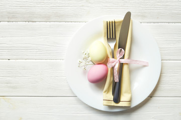 Easter laying table appointments, table setting options. Silverware, tableware items with festive decoration. Fork, knife and flowers. Happy easter holiday.