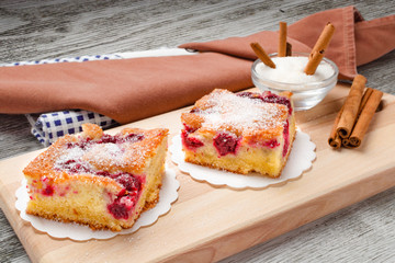 Sour cherry cake. Slices of sour cherry cake with sugar and cinnamon sticks. 