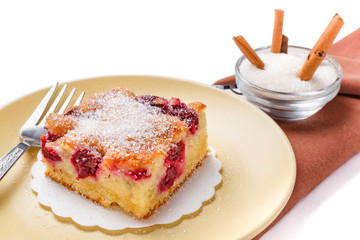 Sour cherry cake. Slices of sour cherry cake with sugar and cinnamon sticks. 