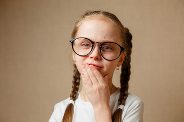 Little girl with glasses in a white t-shirt