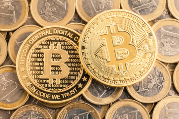 Two golden Bitcoin over Euro coins