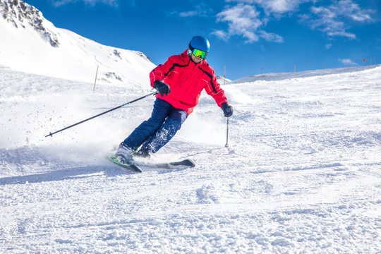 Man skiing on the prepared slope with fresh new powder snow in Tyrolian Alps, Zillertal, Austria