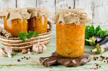 Eggplant caviar in a glass jar on a wooden table