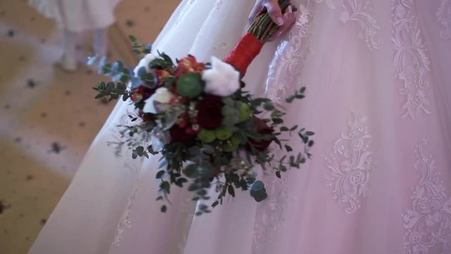 Bride holding wedding bouquet indoors