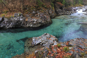 Naklejka na ściany i meble Atera river in japan with waterfalls in autumn.