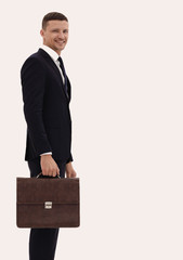 confident businessman with briefcase. side view