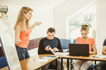 Students and teacher tutor in classroom