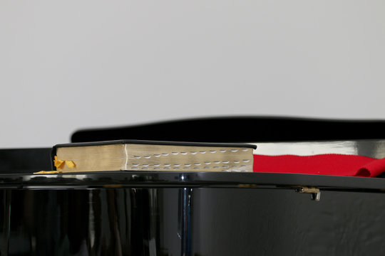 The Bible on the Black Piano