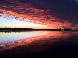 Vivid Colourful sunset reflecting on the beach