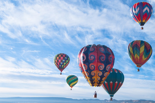 Colorful Hot Air Balloons Flying Over The Mountain.  New Maxico, USA.