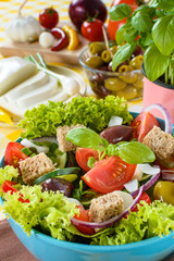 Fresh vitaminic green salad with bread cubes and tasty selection of vegetables.