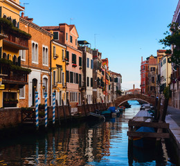 Fototapeta na wymiar Beautiful Venice sunset cityscape, narrow water canal, bridge and traditional buildings. Italy, Europe.