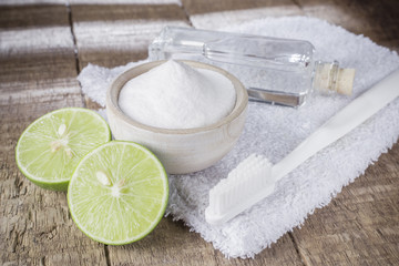 baking soda and lemon on wooden table