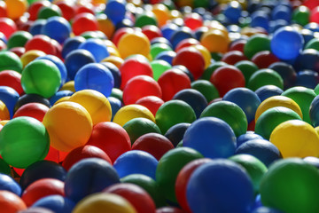Background texture of multi-colored plastic balls on the playground.