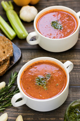 Thick Italian soup minestrone on a wooden table