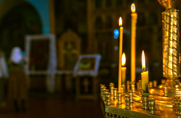 Christening in the church. Catholicism and Orthodoxy. candle on a blurred background.