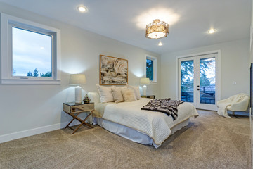 New luxury custom built home with white master bedroom.