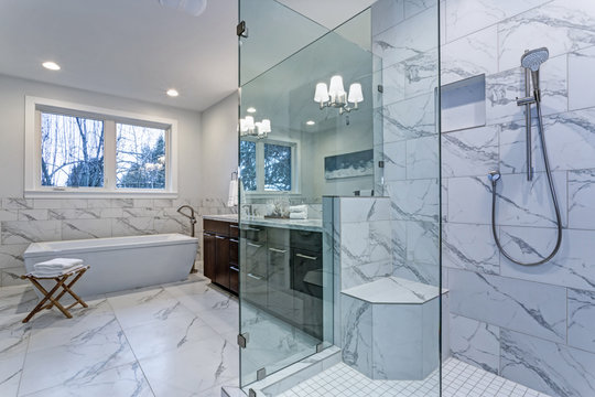 Incredible master bathroom with Carrara marble tile surround.